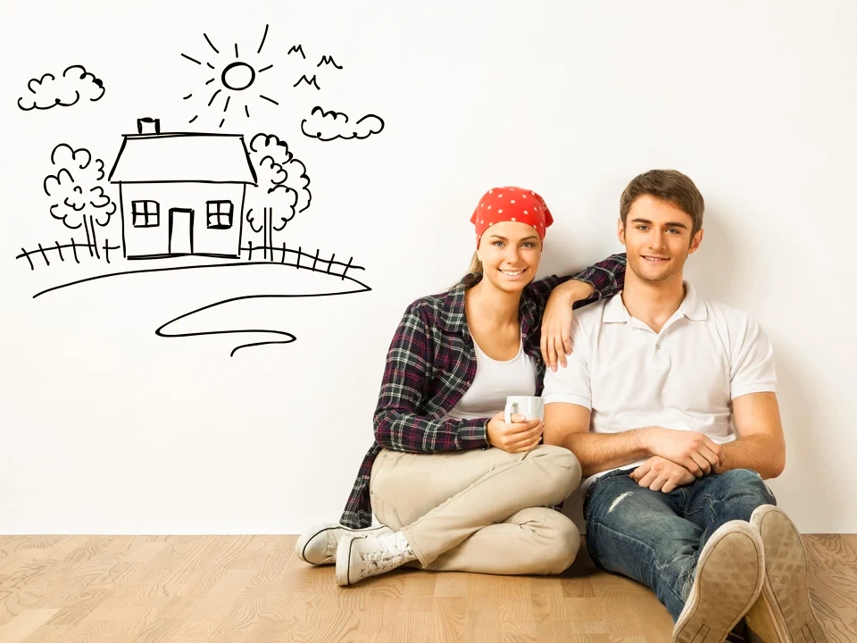 Jeune couple assis par terre dans une chambre